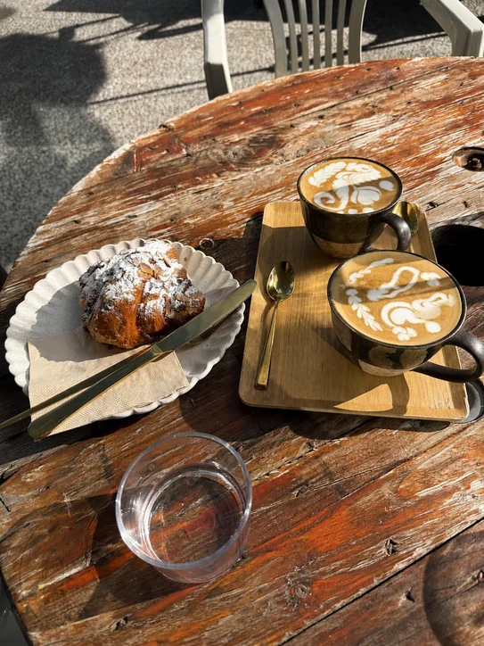 Coffee and a croissant on a table